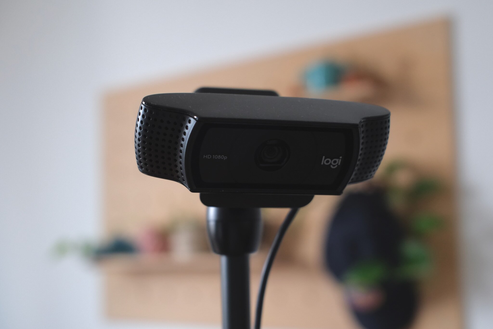 The Logitech C920 webcam attached to a desk via a small articulated arm.