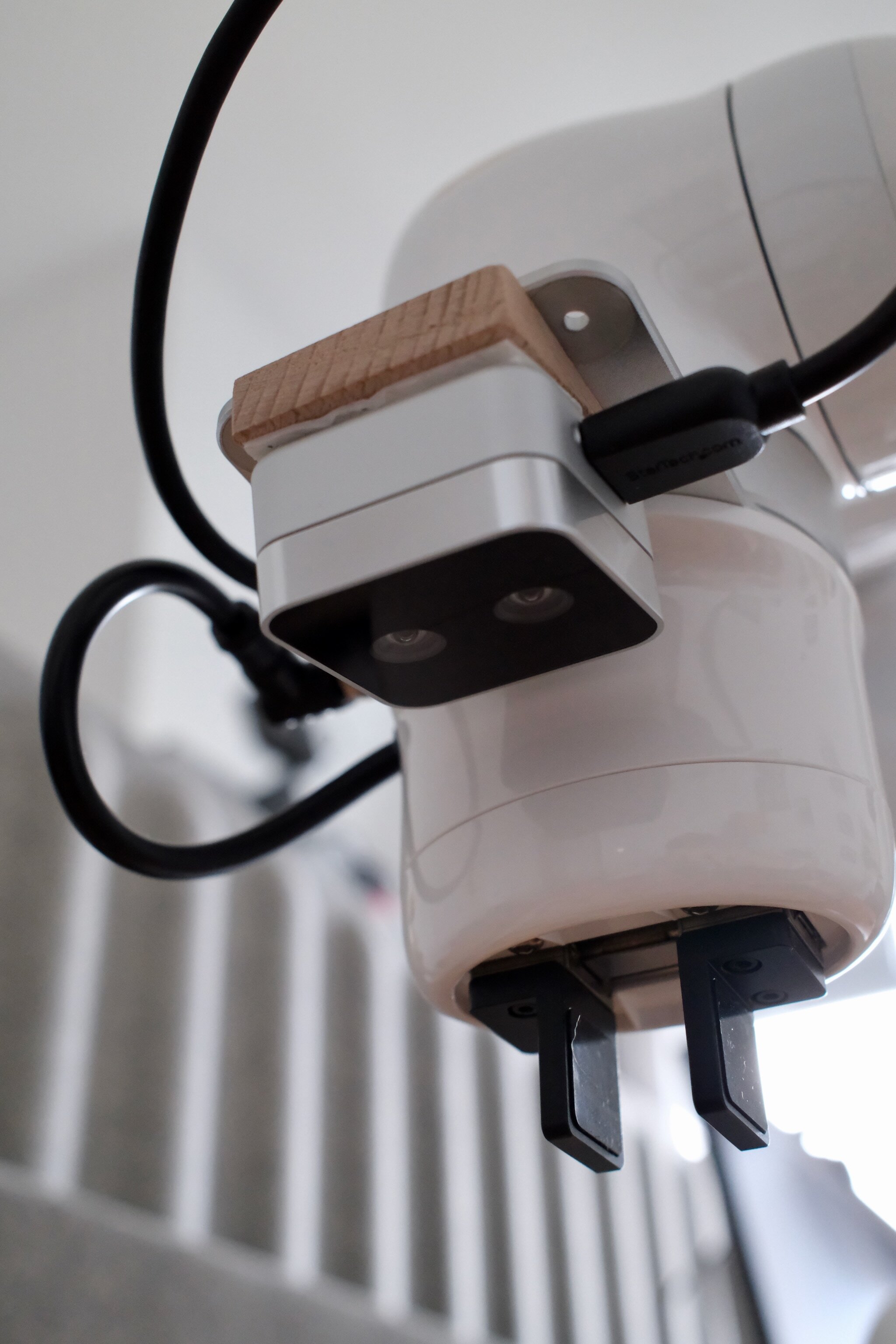 The Intel RealSense D405 attached to the robot wrist via a wooden angle mount.